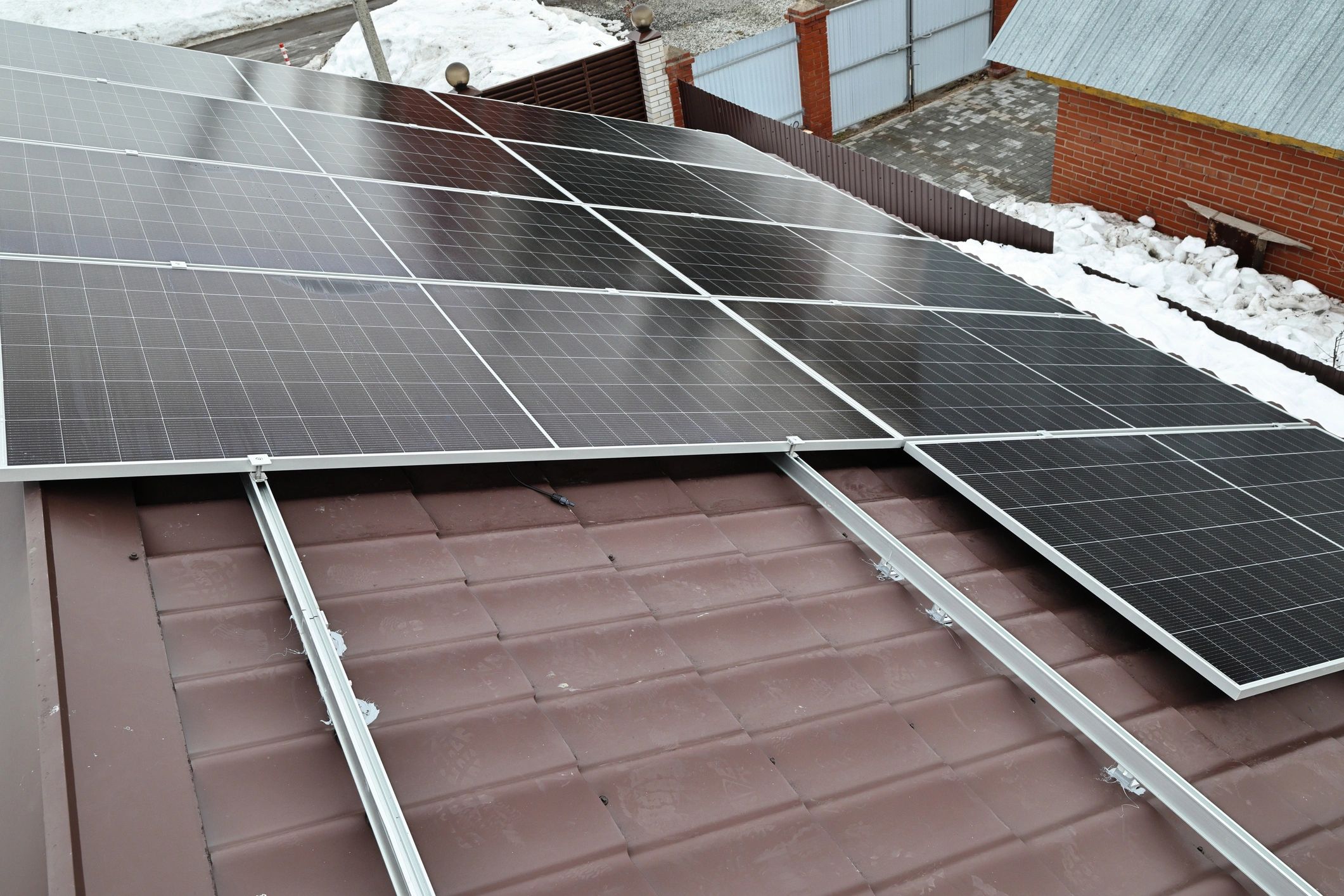Residential Solar Panel Array Installation on Brown Tiled Roof